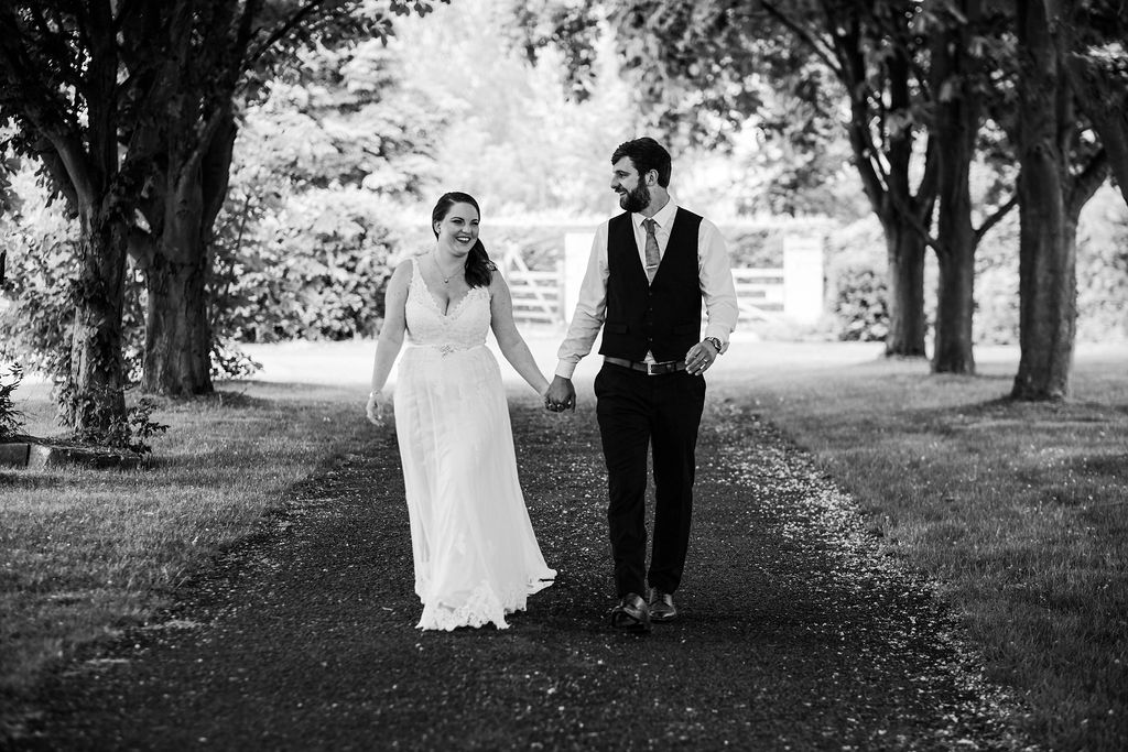 Bridal couple walking in the gardens, Swynford Manor